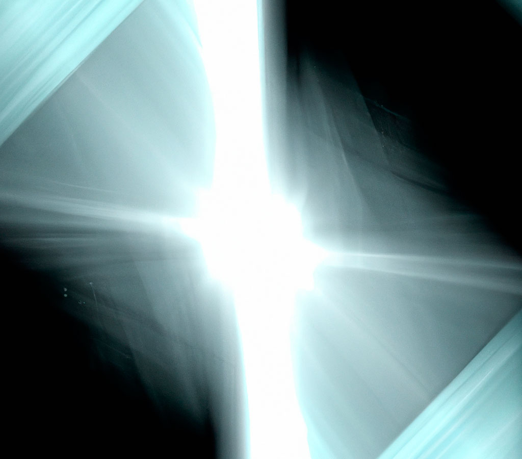 DALL·E-2023-06-08-12.59 A light source on a dark background from the front forms a luminous cross